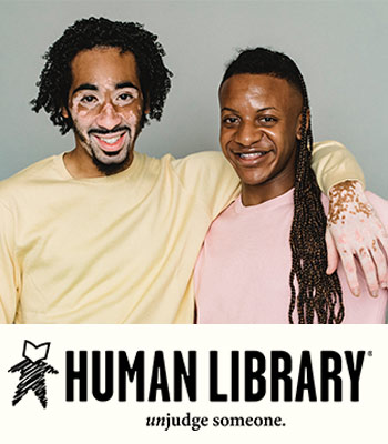 Two people standing next to each other, one with their arm around the other. Below that it is the human library logo and text that says Human Library Unjudge Someone